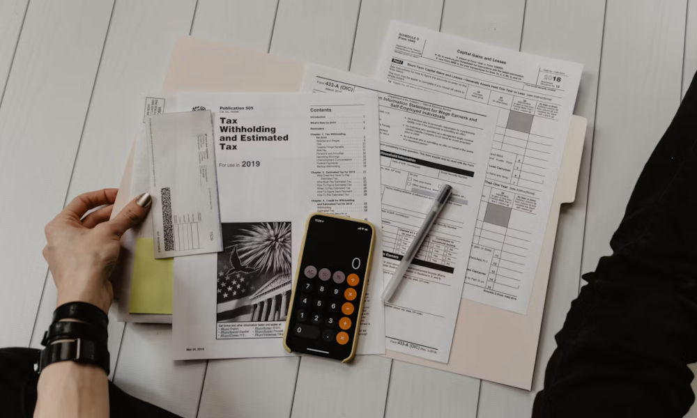 Calculator and financial paperwork used to tally costs
