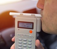 driver-using-breathalyzer