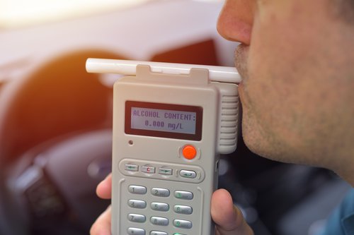 driver-using-breathalyzer