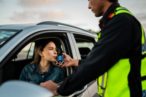 young-woman-breathing-into-breathalyzer